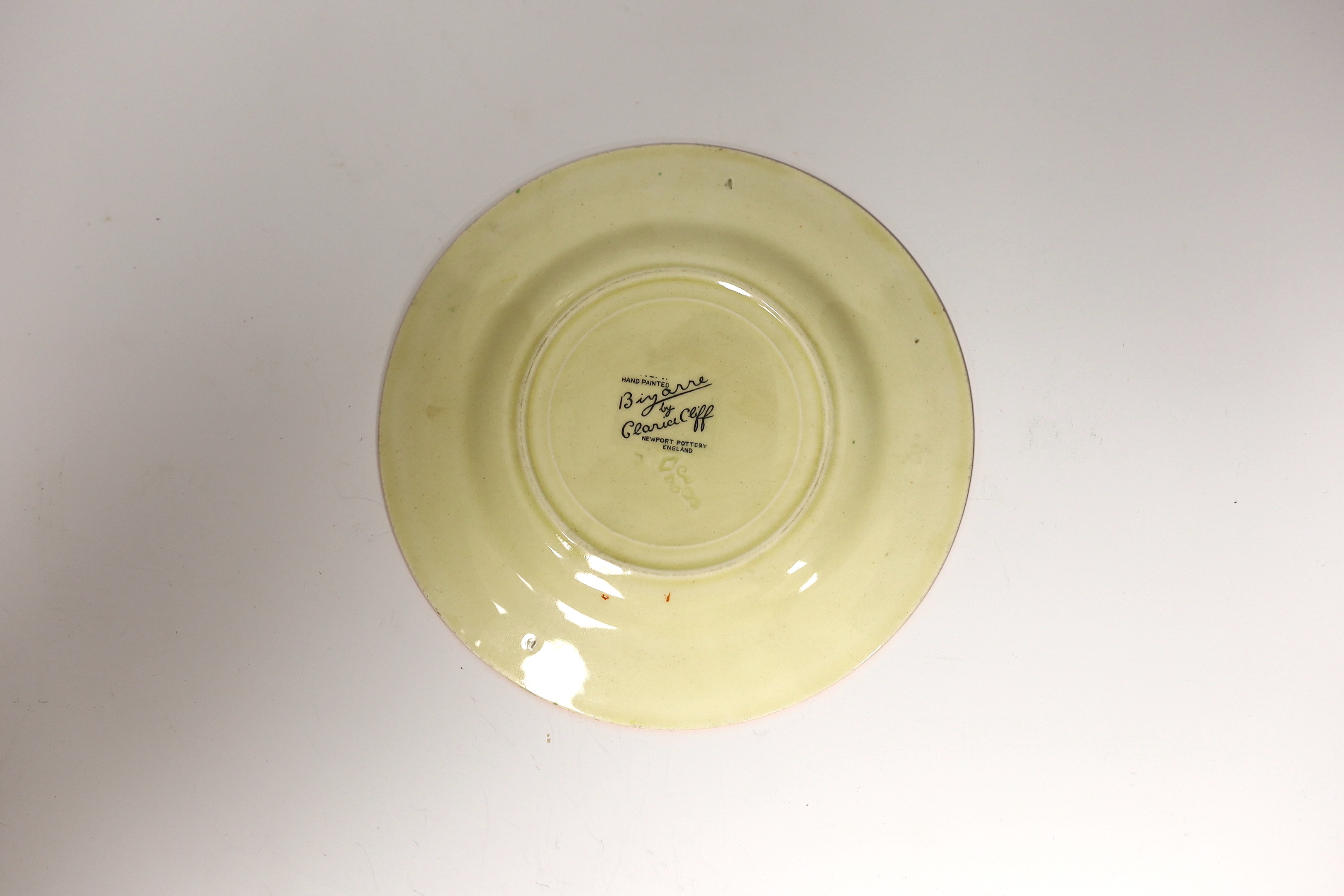 A Clarice Cliff side plate, Orange Roof Cottage, impressed date 1932, 15cm